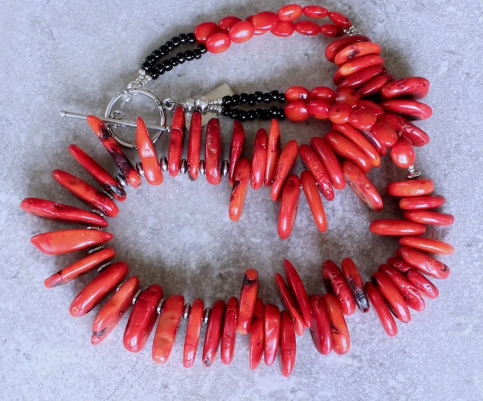 Bamboo Coral Disc Graduated Necklace with Sterling Silver Discs, Black Indonesian Glass Rondelles, Bamboo Coral Ovals, and a Sterling Silver Toggle Clasp