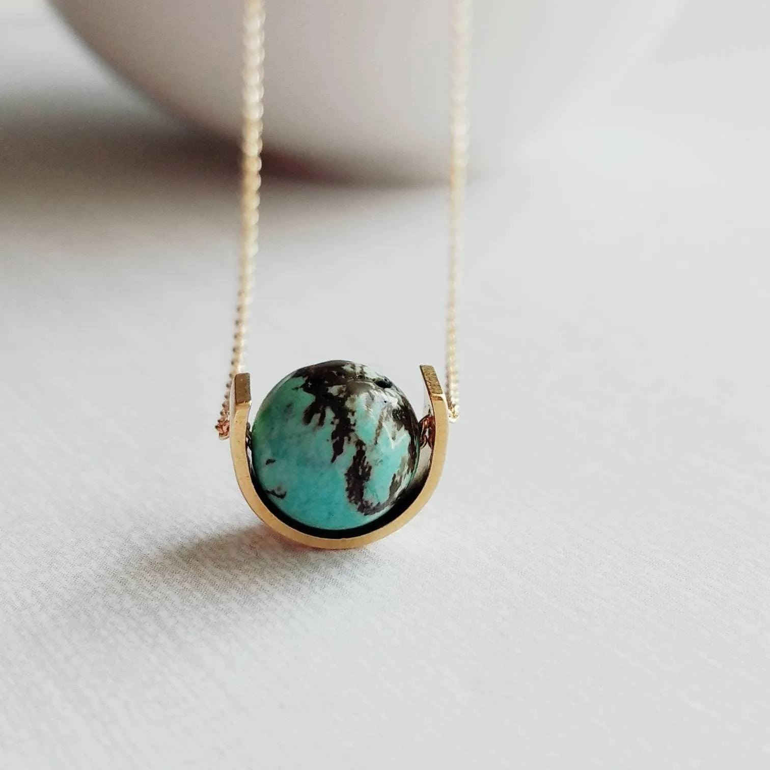 Gold Eclipse Necklace, turquoise blue stone, howlite necklace, brown black veining, round gemstone necklace, gold semicircle pendant, modern